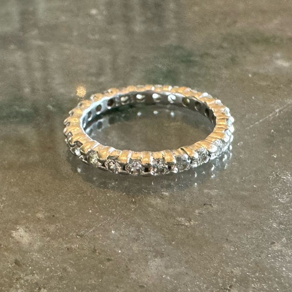 14 karat white gold round diamond eternity band. 1 karat total weight.